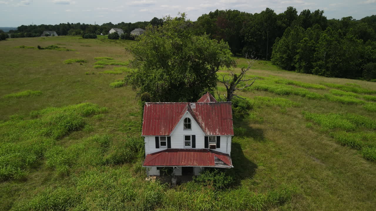 Abandoned house in grassy field