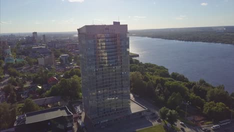 aerial view of a city with a tall building next to a river