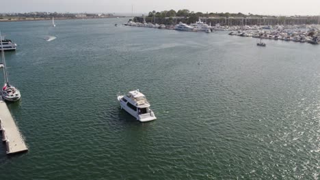 drone shot of yacht pulling into harbor