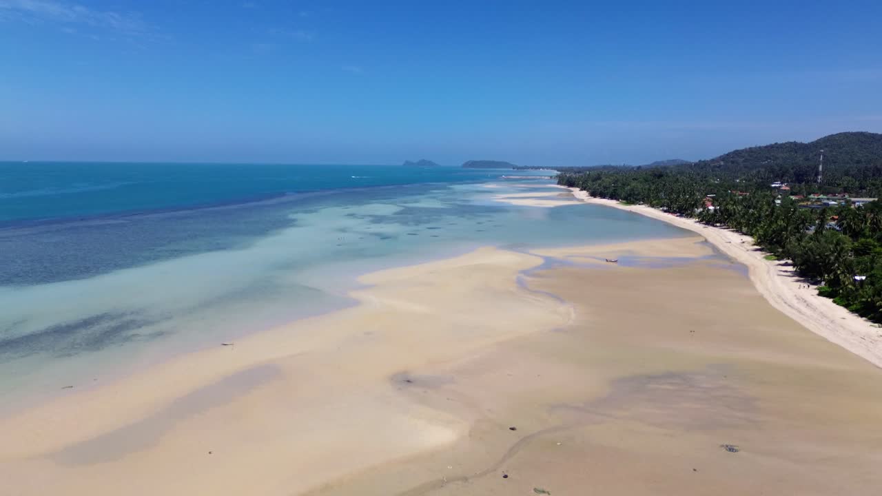 Stunning drone footage capturing Koh Phangan coastline, pristine beaches, and green mountains under clear skies, perfect for travel, nature, and tropical scenery projects