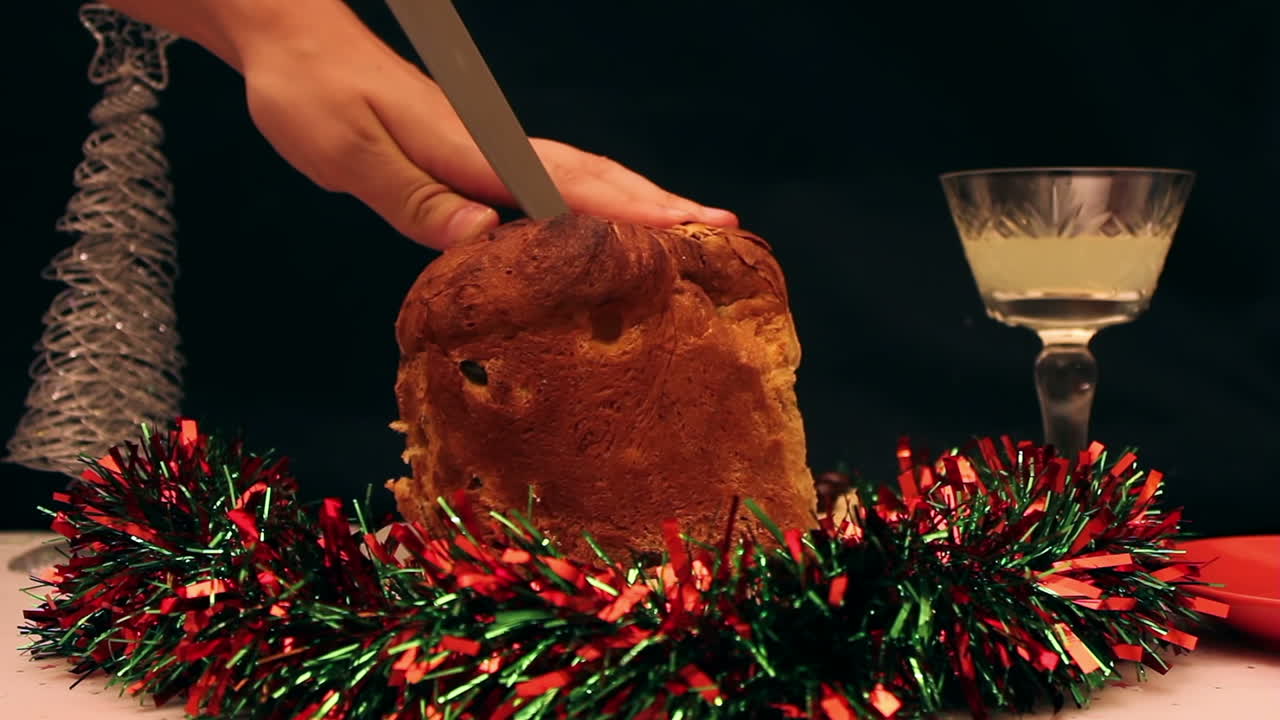 Hand Cutting a Slice of Panettone Christmas Bread