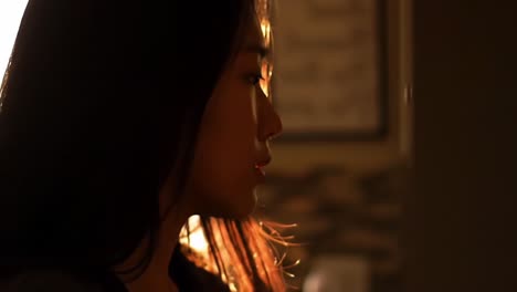 a profound moment captured: a woman's contemplative expression in gentle remnants of evening light illuminating her profile