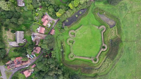 Aerial-video-footage-of-the-remains-of-Bolingbroke-Castle-a-13th-century-hexagonal-castle,-birthplace-of-the-future-King-Henry-IV,-with-adjacent-earthwork