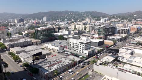 Hollywood,-California---rising-aerial-reveals-the-building-in-Hollywood-with-the-mountains-in-the-background