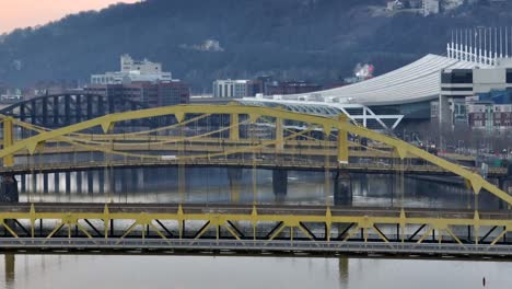 Aerial-rising-shot-of-yellow-steel-bridges-in-Pittsburgh-PA