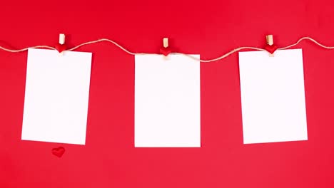 papeles con corazones para el día de san valentín aparecen y gancho en la cuerda en el tema rojo. detener el movimiento