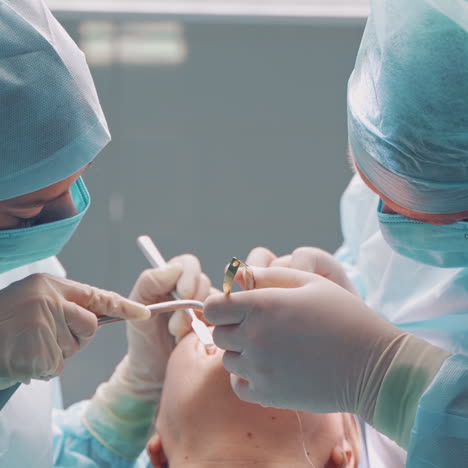 dental implant surgery. dentists during surgery for implant placement