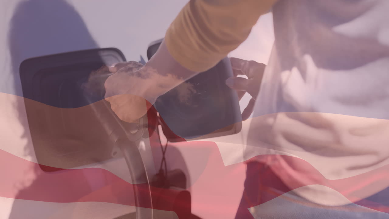 bandera de gran bretaña sobre la sección media de un hombre caucásico cargando un coche eléctrico