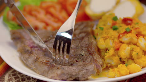 meat steak with corn tomatoes, lettuce and potatoes