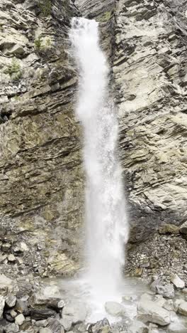 majestic waterfall crashes down a rugged cliffside in réallon, france, showcasing raw power and natural serenity in an alpine mountain setting.