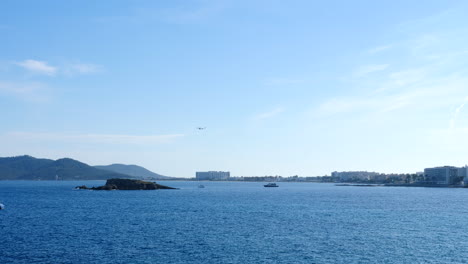 ibiza city bay with airplane landing on a sunny summer day satic