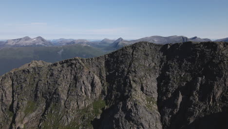 drone approaching rough edge of romsdalseggen, hiking spot in andalsnes, norway