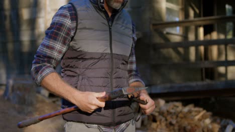 Male logger holding axe in the forest 4k