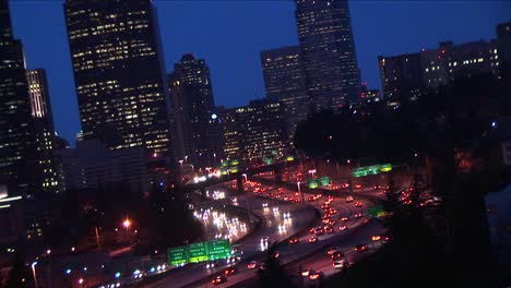 a closeup of downtown seattle buildings with heavy traffic flowing along major expressways