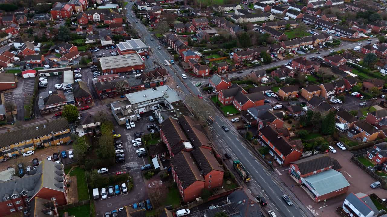 Landscape drone footage panning over the Locks Heath area in Hampshire, South England. A small village near Southampton with a beautiful golden sunset overhead and small suburban houses below
