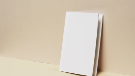 video of book with white blank pages and copy space on yellow background