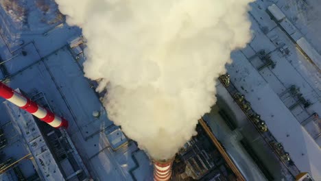 industrial facility with smoke emission in winter