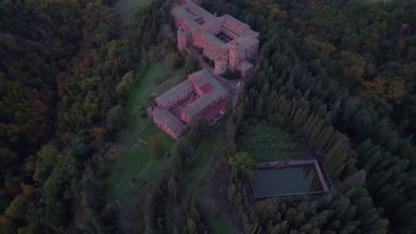 Above-Territorial-Abbey-of-Monte-Oliveto-Maggiore-at-sunrise,-Italy