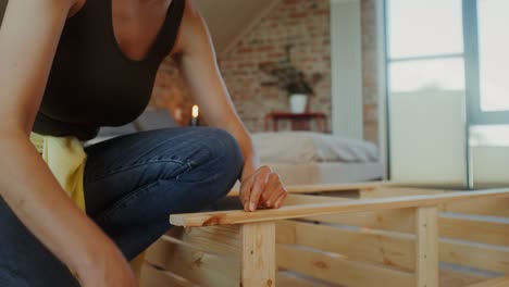 woman assembling wooden furniture