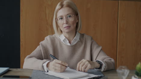 woman taking notes in office