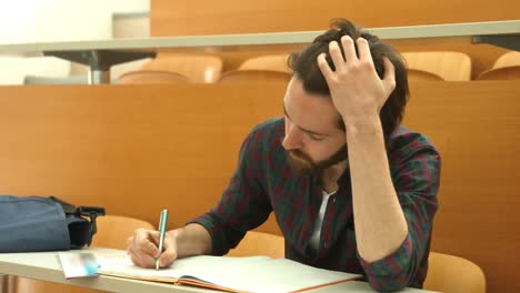 stressed student taking down notes