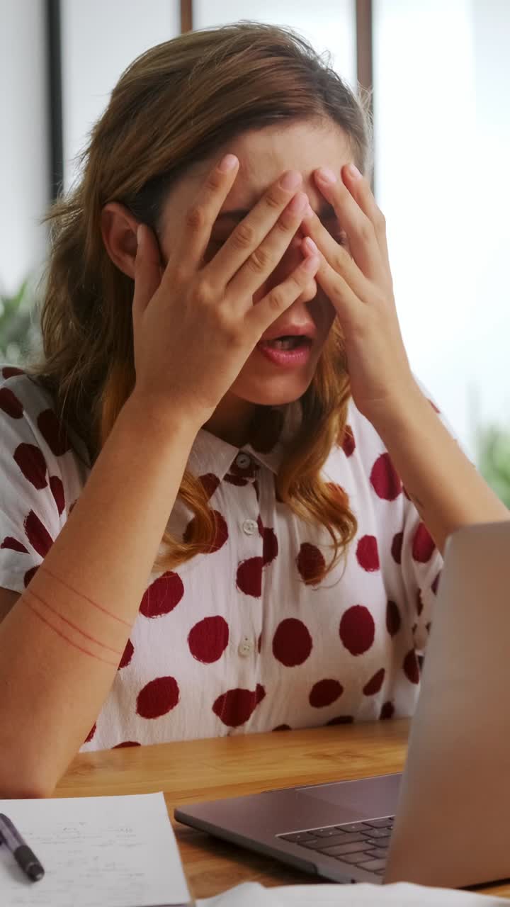 Woman works at home on laptop during daytime
