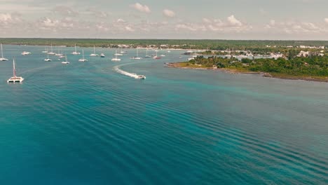 motorboat exiting from bayahibe port and navigating on blue sea waters, la romana in dominican republic