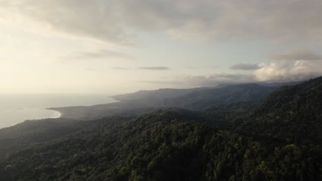 drone over costa rica coastline during sunset with wild jungle in 4k