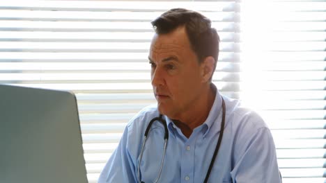 Male-doctor-working-on-personal-computer