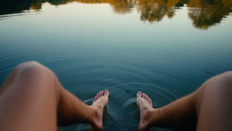 dipping feet in serene lake water