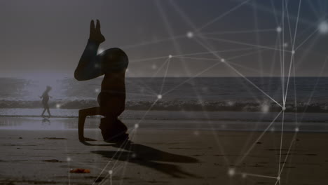 animation of networks of connections over caucasian woman praciticing yoga on beach