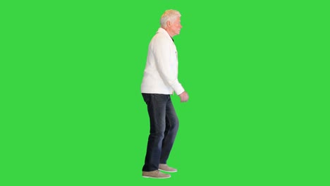 casual senior old man walking on a green screen, chroma key