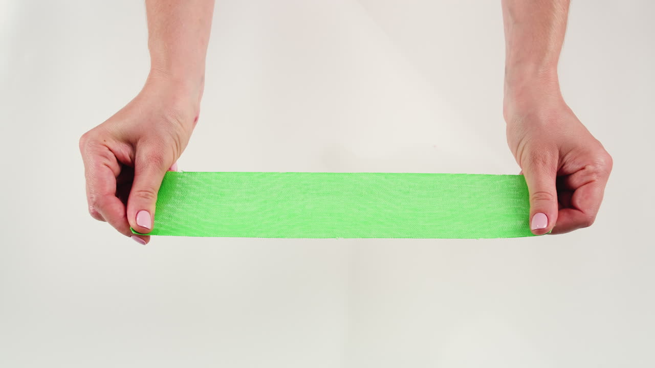 Kinesiology medical taping, doctor Physical therapist applying elastic surgical tape to patient body, treating injured knee young athlete.Post traumatic rehabilitation, sport physical therapy recovery