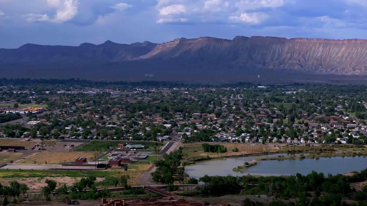 Colorado River summer Grand Junction aerial drone Grand Mesa afternoon cloudy blue sky wine vineyards Parachute Fruitvale Mt Garfield Western Close Delta downtown Main Street circle right motion