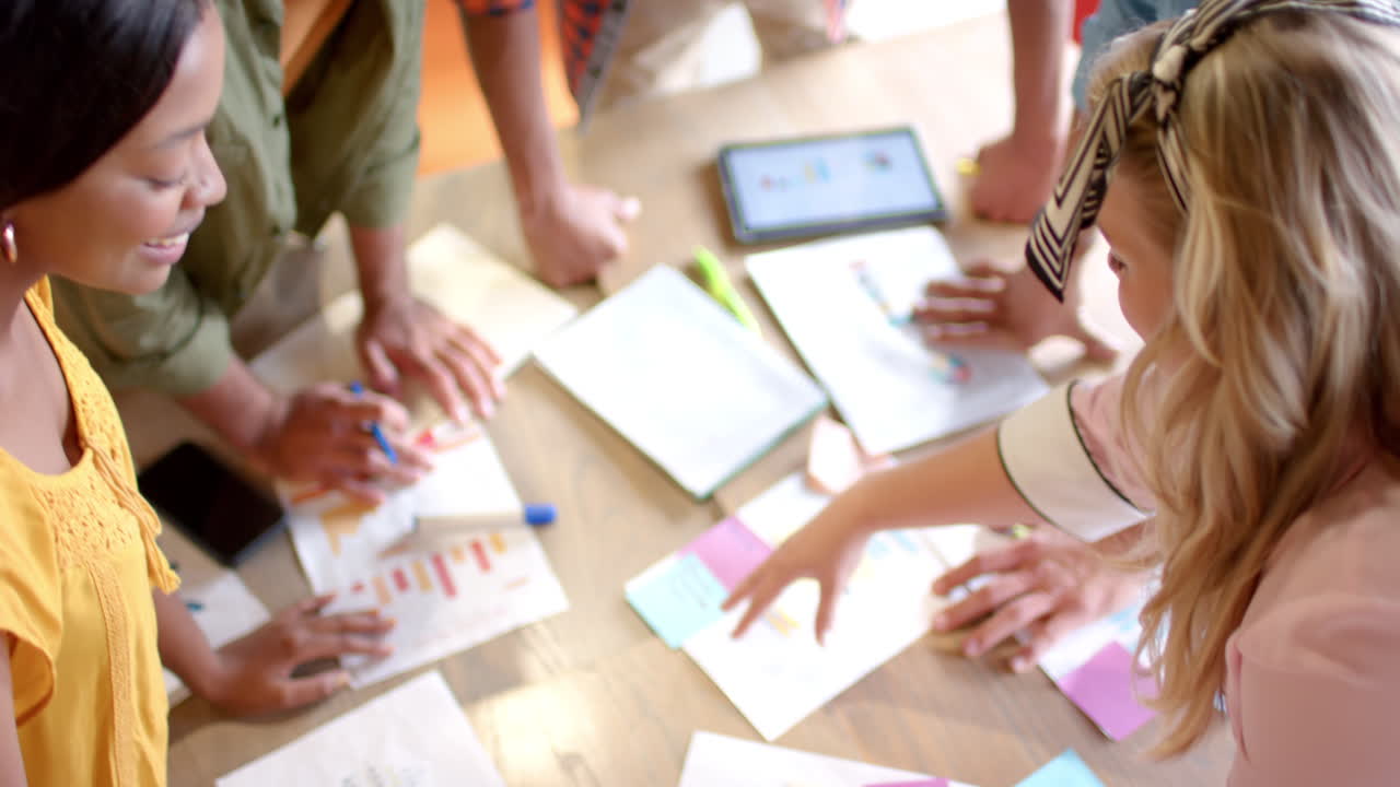 A diverse team collaborates in a casual business, bright office setting