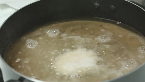 close-up of deep frying potatoes