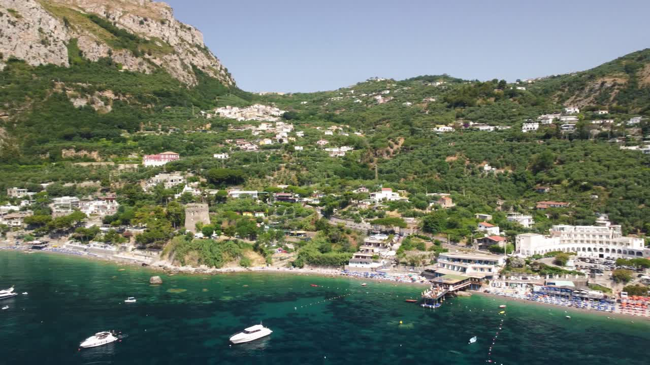 Aerial view from right to left of Amalfi Coast in Punta Campanella Natural Park,Italy with beautiful panoramic view of the coastline on summer day