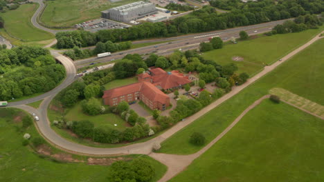 Circling-aerial-shot-over-roadside-hotel-revealing-Stevenage-town-UK