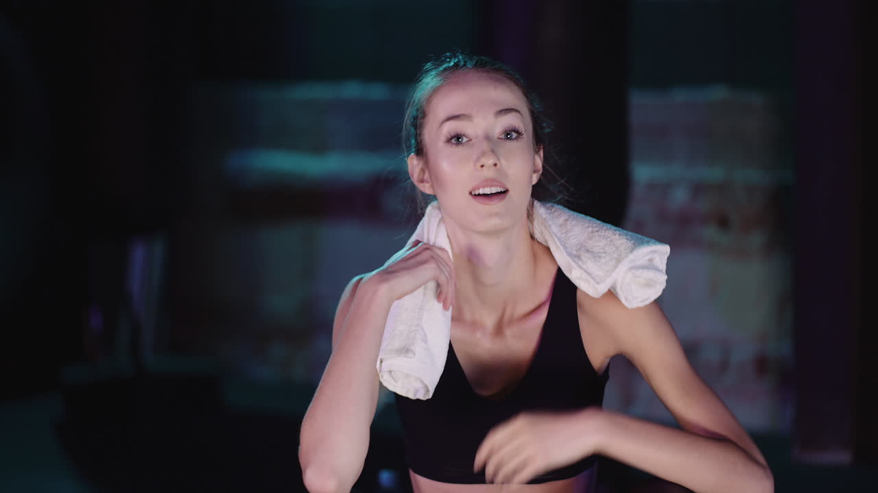 Slow Motion Of Slim Female Athlete Drinking Water From Bottle At Fitness Club