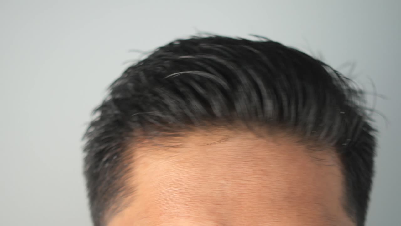 Person brushing and styling hair with a comb