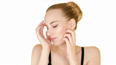 young beautiful model in a sensual way touching and stroking her face gently