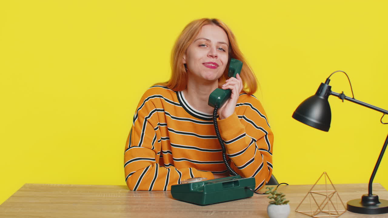 Woman advertising phone call having conversation on wired retro telephone helpline hotline support