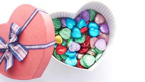 heart-shaped box filled with colorful chocolates