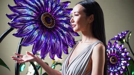 woman with a large glass flower sculpture