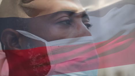 Animation-Der-Flagge-Russlands,-Die-Während-Der-Covid-19-Pandemie-über-Einem-Mann-Mit-Gesichtsmaske-Winkt