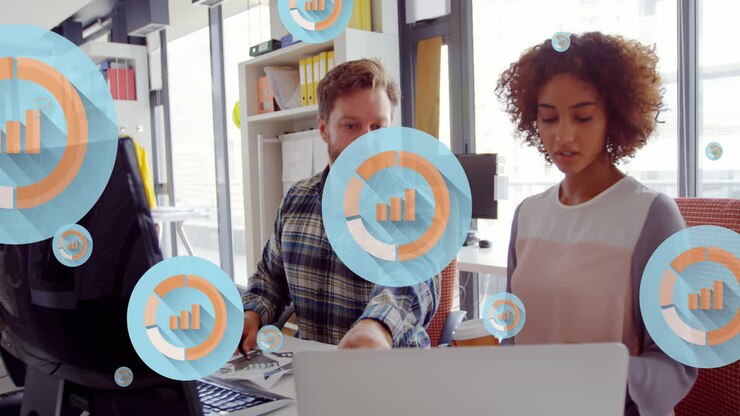 Animation of multiple graph icons over diverse coworkers discussing on desk in office