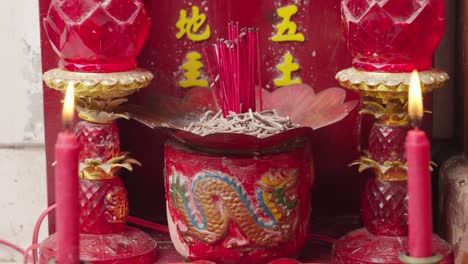 chinese prayer sanctuary with incense and candles