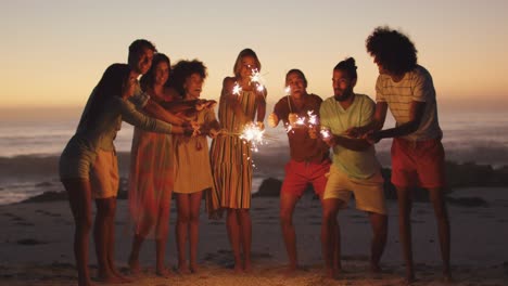 friends playing with fire on the beach