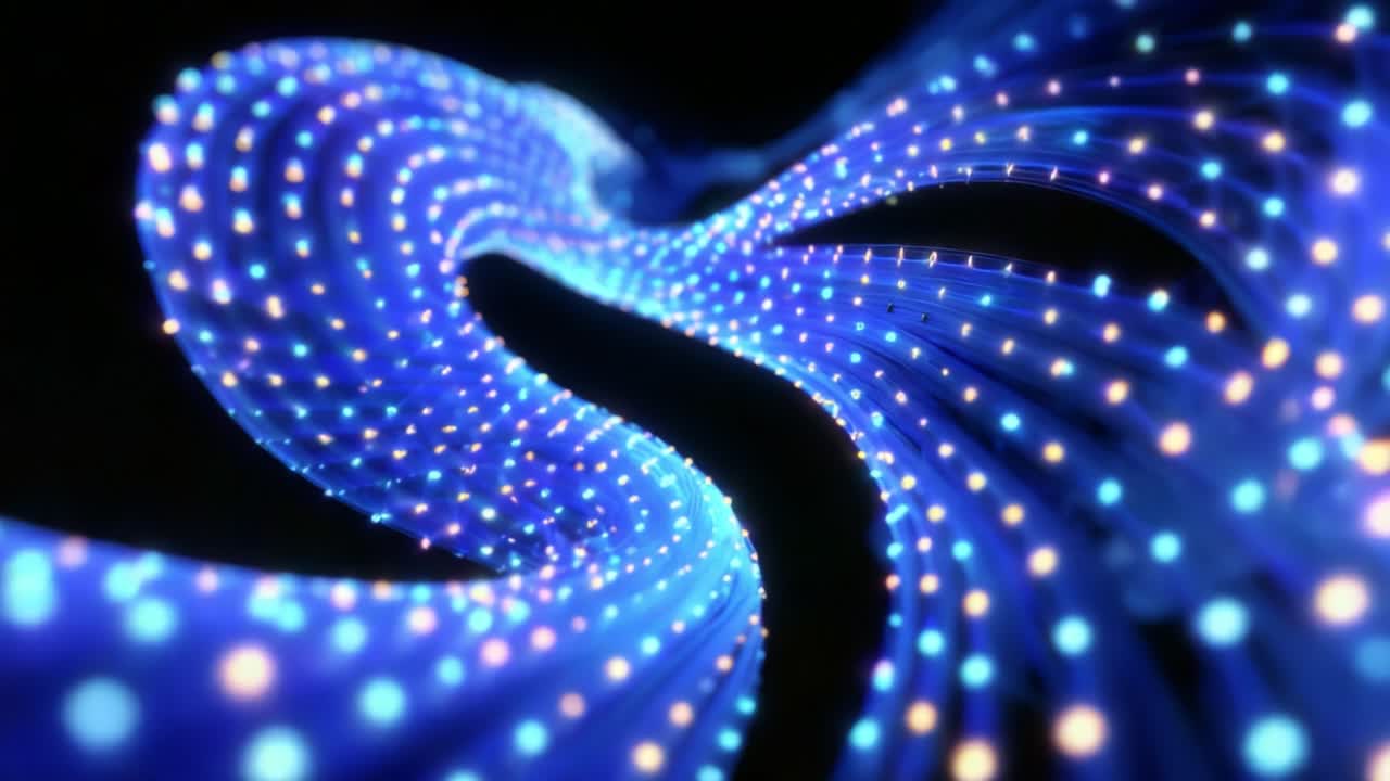 A mesmerizing display of interconnected glowing blue strands creates a vibrant wave-like motion, illustrating the beauty of light and technology in an abstract digital animation