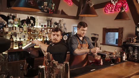 bartenders making cocktails at a bar